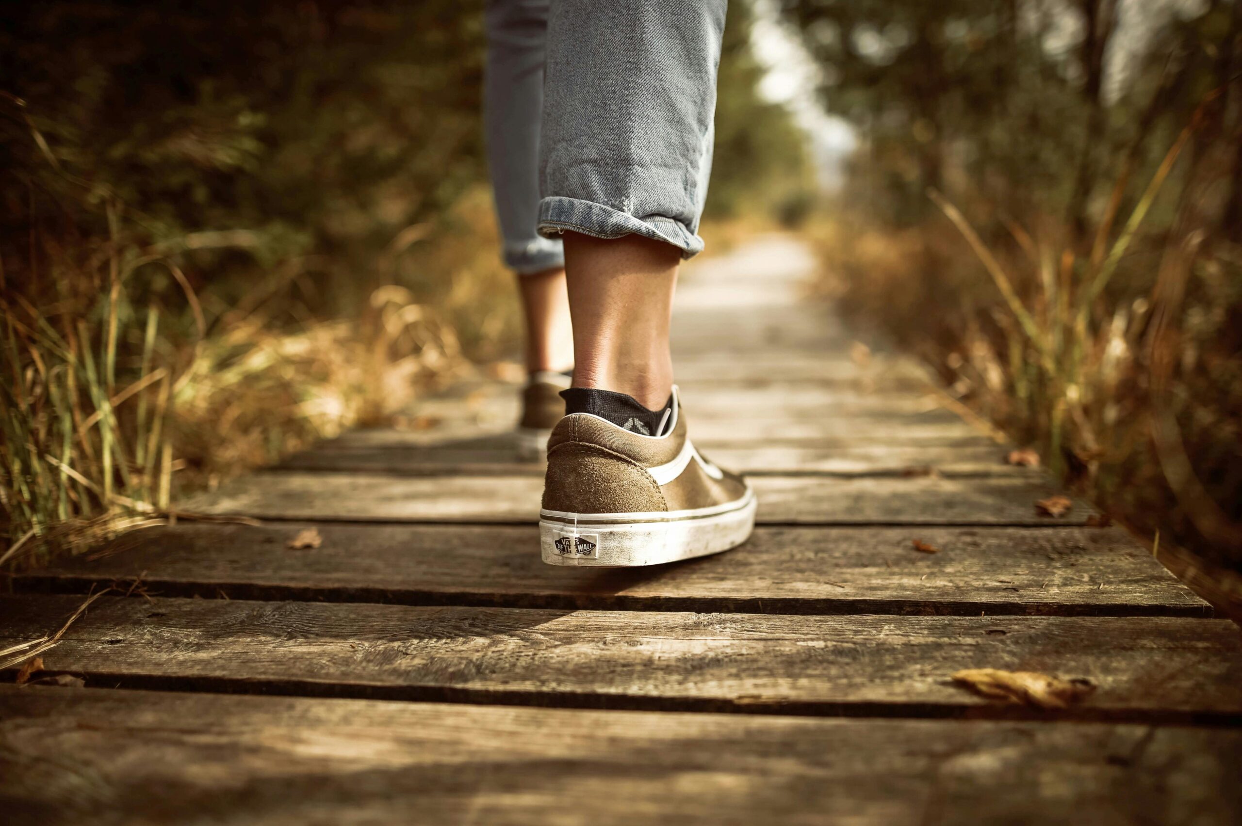A woman walking gently outdoors, practicing mindful movement and connecting with God through her body
