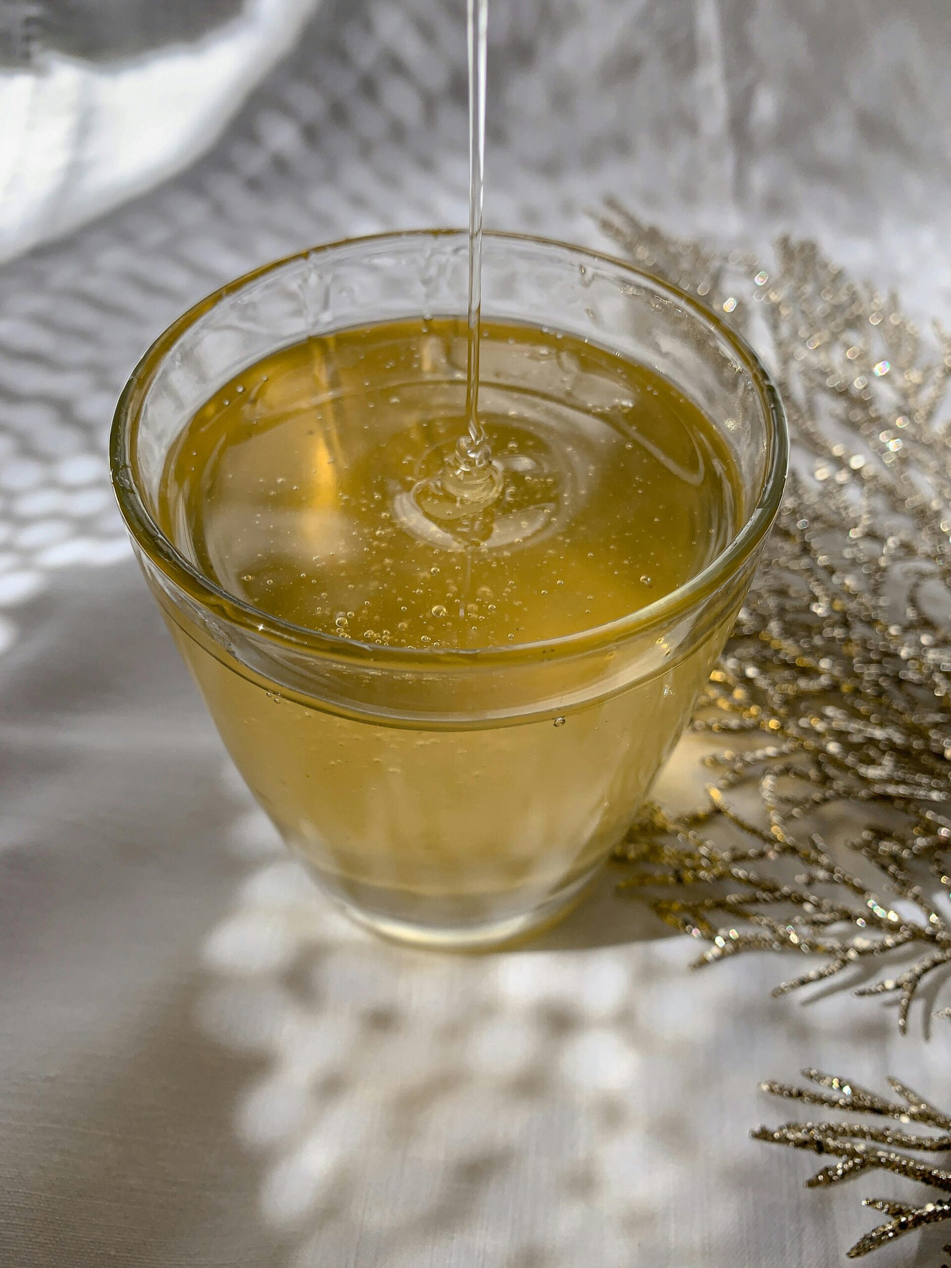 A glass of golden oil being poured, symbolizing the overflow of God’s grace—symbolizing learning to receive from God.