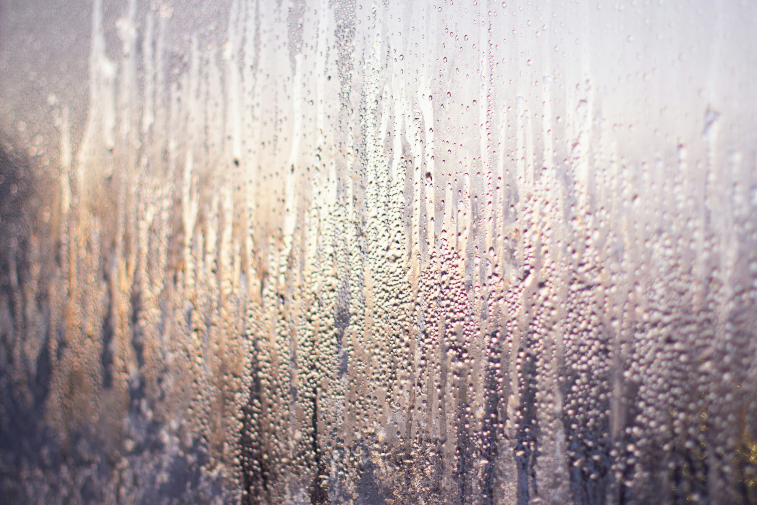 Foggy window with water drops, symbolizing quiet grief and emotional strength during hard seasons.